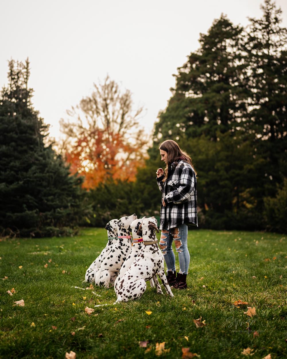 Bridgitte with her pack of Dalmatians